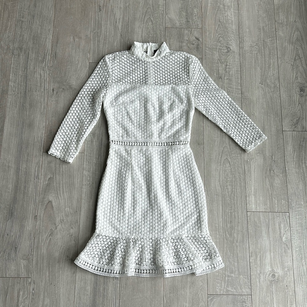 This white fitted midi dress has “old money” energy with a crocheted- style-mesh